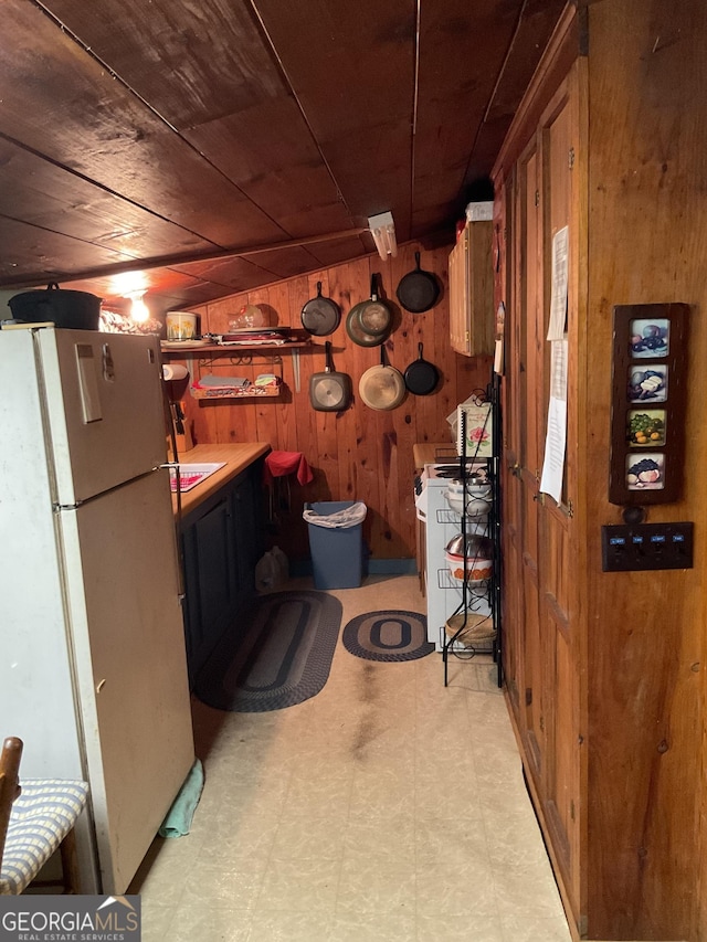 bathroom featuring wood ceiling and wooden walls