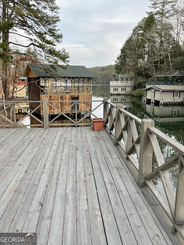 wooden deck featuring a water view