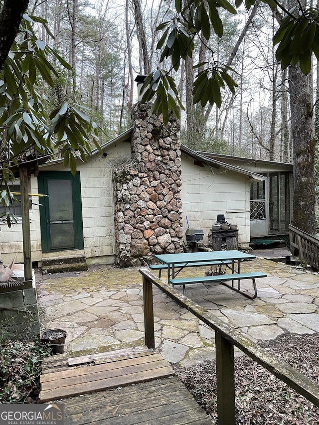 view of patio with a sunroom