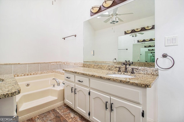 bathroom with vanity, a tub, and ceiling fan