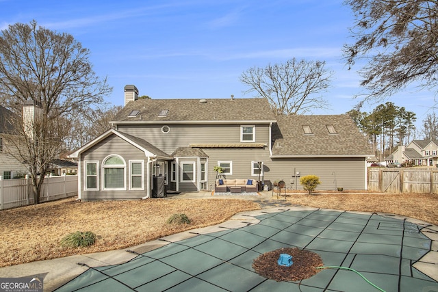 rear view of property with an outdoor hangout area, a patio, a covered pool, and central air condition unit