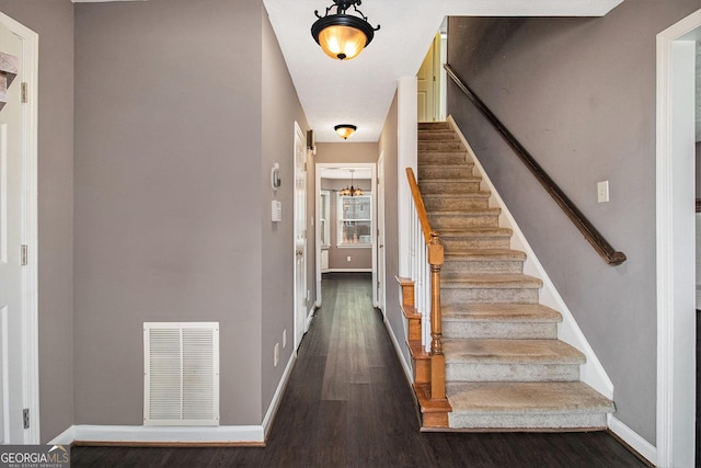 stairs with hardwood / wood-style flooring