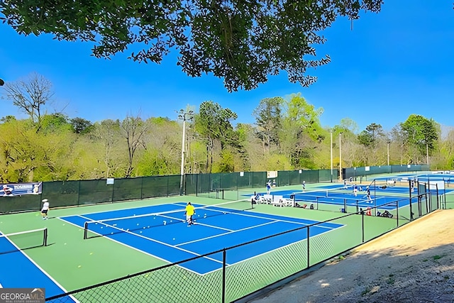 view of tennis court with basketball hoop