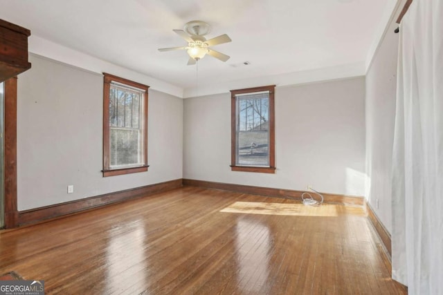 spare room with hardwood / wood-style flooring and ceiling fan