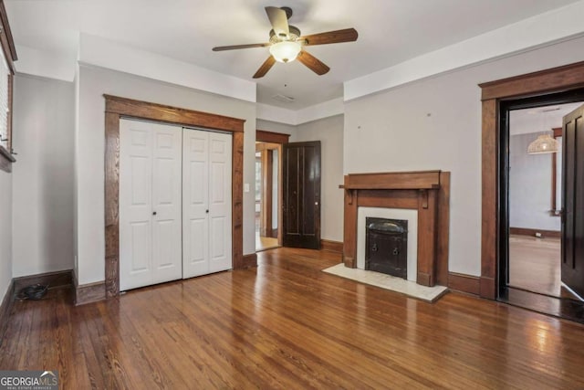 unfurnished living room with hardwood / wood-style floors and ceiling fan