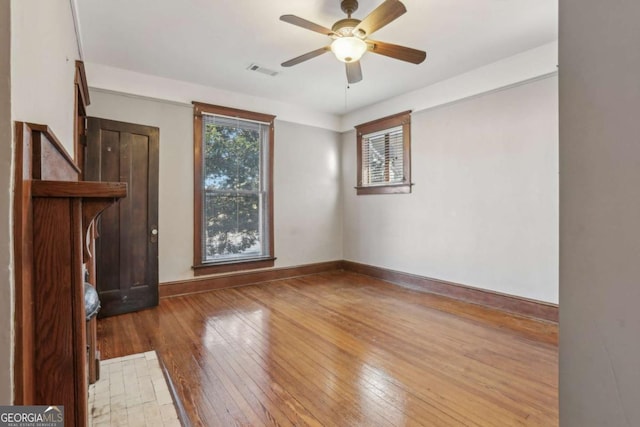 spare room with ceiling fan and hardwood / wood-style floors