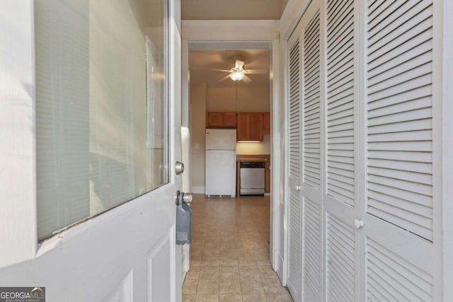 hall featuring light tile patterned flooring