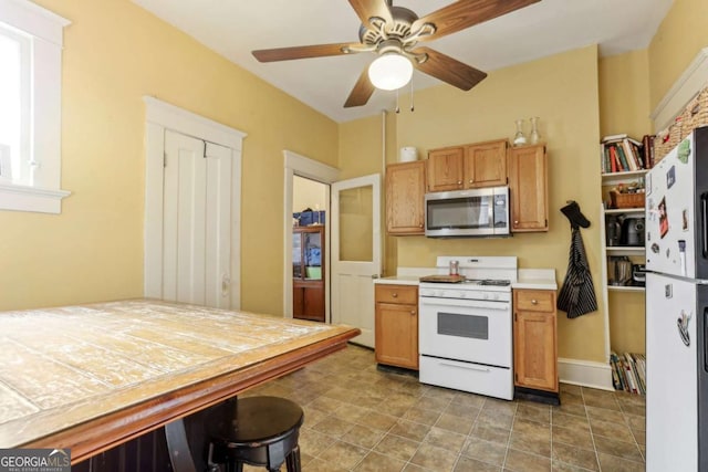 kitchen with ceiling fan and white appliances