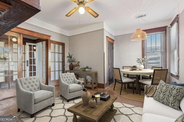 living room featuring ceiling fan and light wood-type flooring