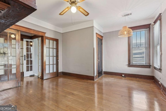 unfurnished room with hardwood / wood-style floors and ceiling fan