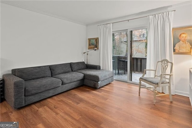 living room with hardwood / wood-style floors and crown molding