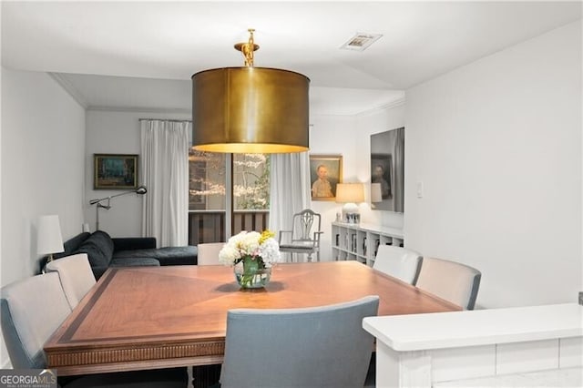 dining area featuring ornamental molding