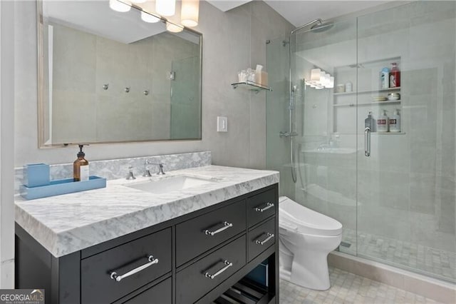 bathroom featuring vanity, a shower with shower door, and toilet