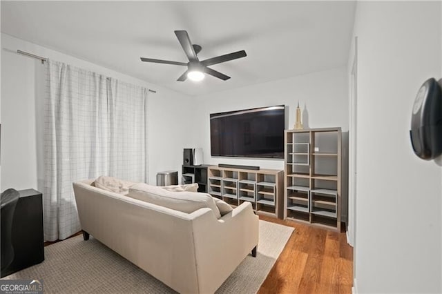 living room featuring ceiling fan and light hardwood / wood-style floors