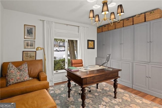 office area with a chandelier and light hardwood / wood-style flooring