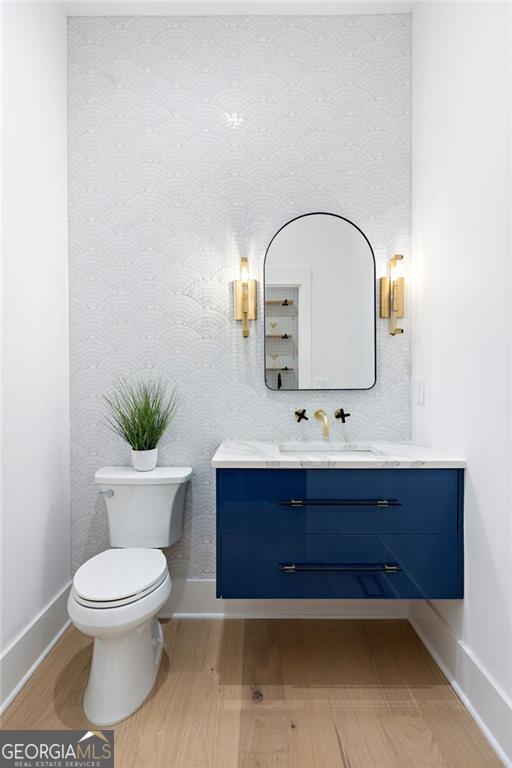 bathroom featuring vanity and toilet