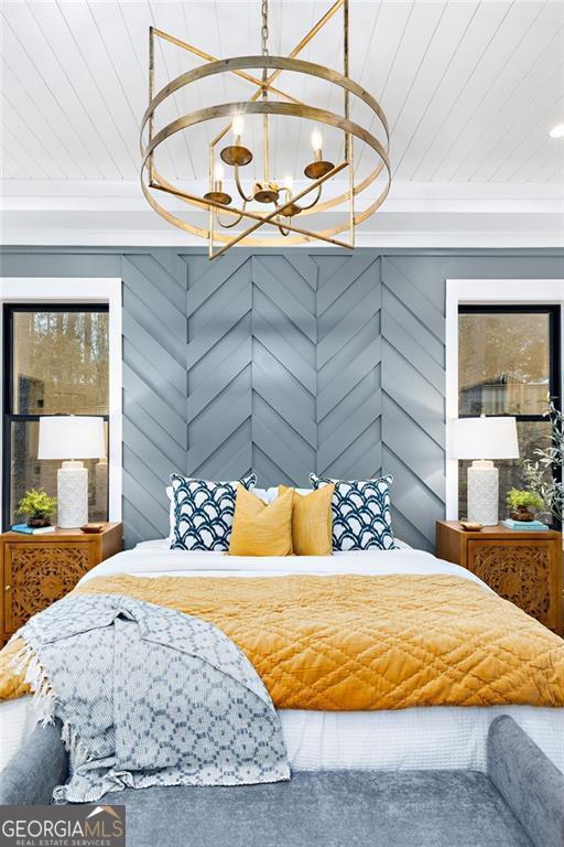 bedroom with a notable chandelier and wood ceiling