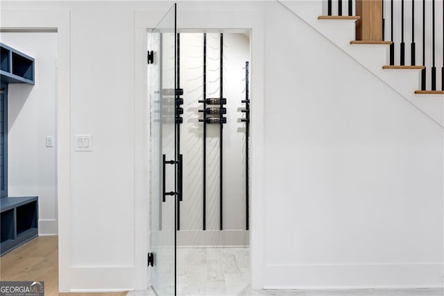 stairs with hardwood / wood-style flooring