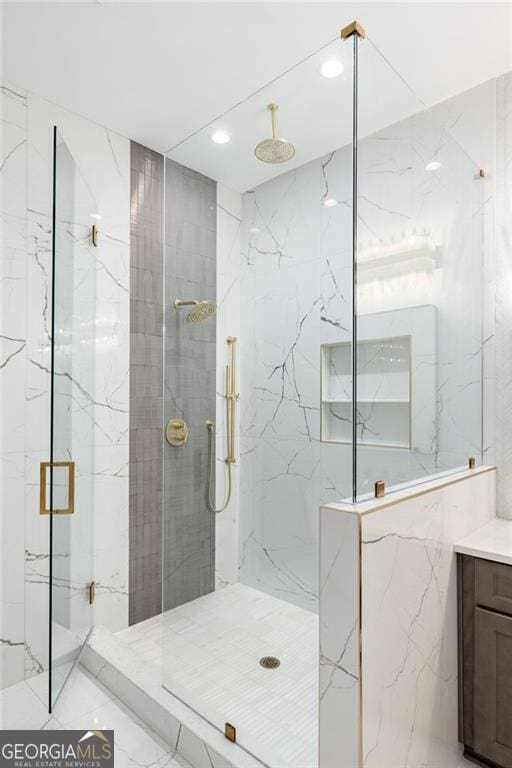 bathroom featuring an enclosed shower and vanity