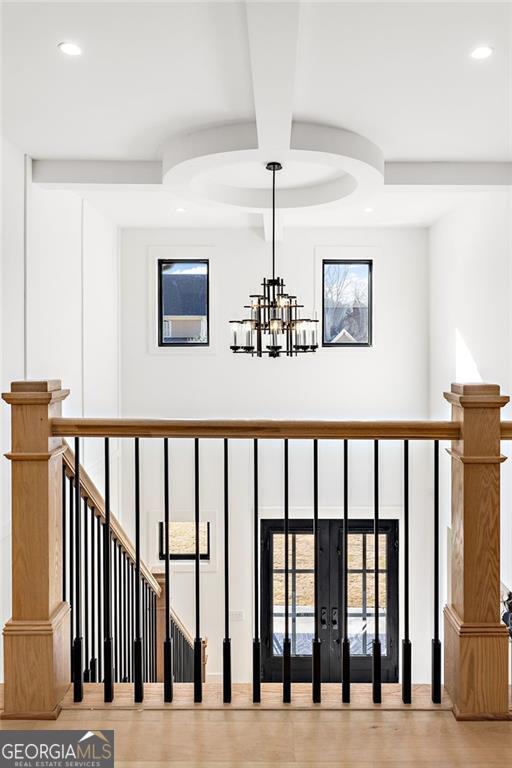 details with an inviting chandelier, hardwood / wood-style floors, and beam ceiling