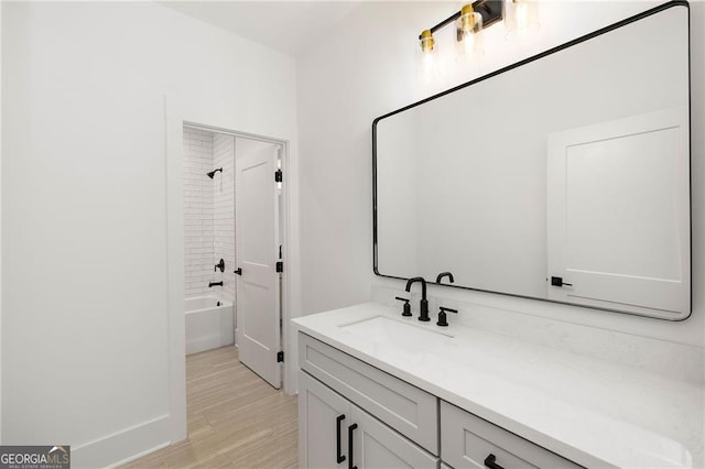 bathroom with vanity, wood-type flooring, and shower / bath combination