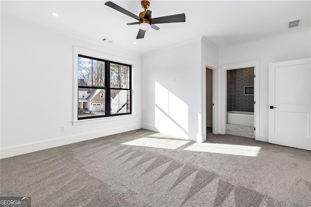 spare room with ornamental molding, ceiling fan, and carpet flooring