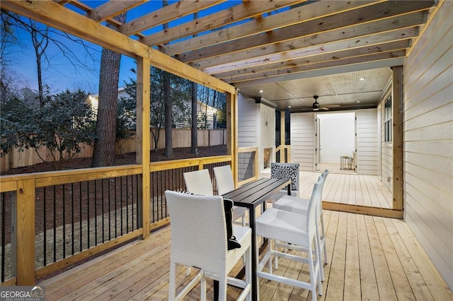 deck featuring ceiling fan and a pergola