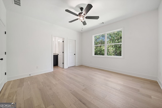 unfurnished bedroom featuring ceiling fan, connected bathroom, and light wood-type flooring