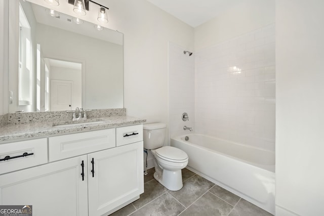 full bathroom featuring vanity, tile patterned floors, toilet, and tiled shower / bath