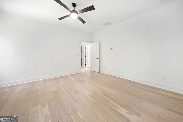 spare room featuring ornamental molding, ceiling fan, and light hardwood / wood-style floors