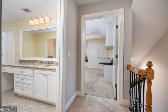 bathroom with tile patterned floors and vanity