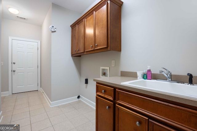 laundry area with sink, hookup for a washing machine, cabinets, and light tile patterned flooring