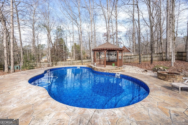 view of swimming pool with a gazebo, a patio, and a fire pit