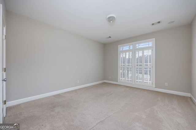 unfurnished room with light carpet