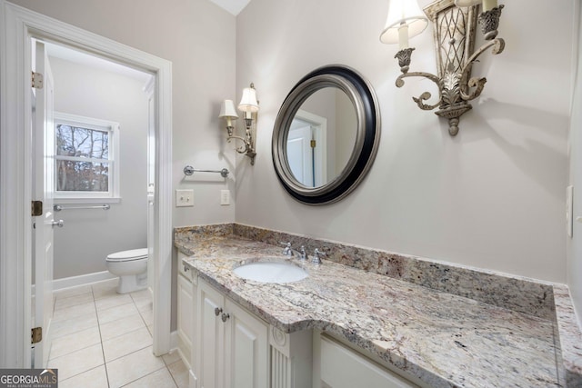 bathroom with vanity, tile patterned floors, and toilet