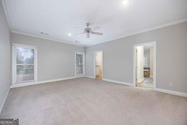 unfurnished bedroom featuring ornamental molding, connected bathroom, and light carpet