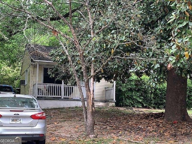 view of property exterior featuring a porch