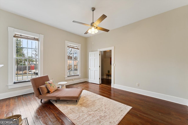 sitting room featuring dark hardwood / wood-style floors and ceiling fan