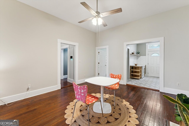 living area with dark hardwood / wood-style floors and ceiling fan