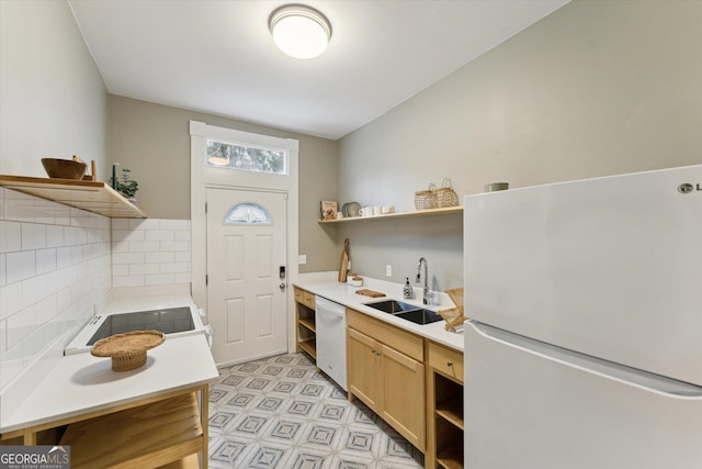 kitchen with tasteful backsplash, sink, white appliances, and light brown cabinets