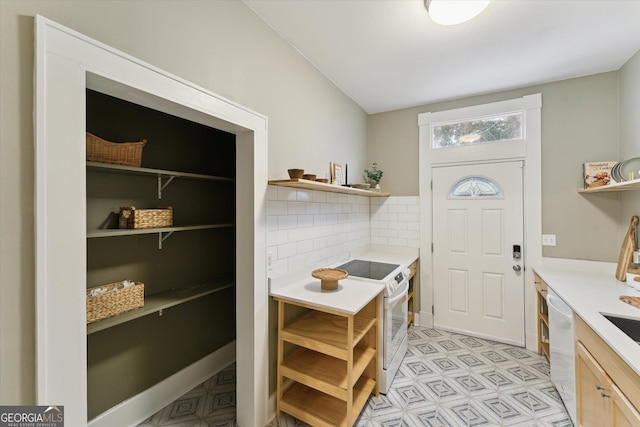 kitchen featuring tasteful backsplash, white appliances, and light brown cabinetry