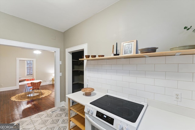 kitchen with light hardwood / wood-style flooring and range with electric stovetop