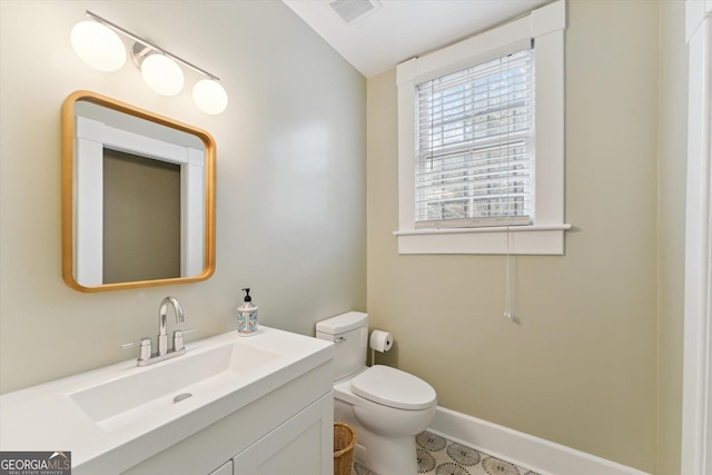 bathroom featuring vanity and toilet