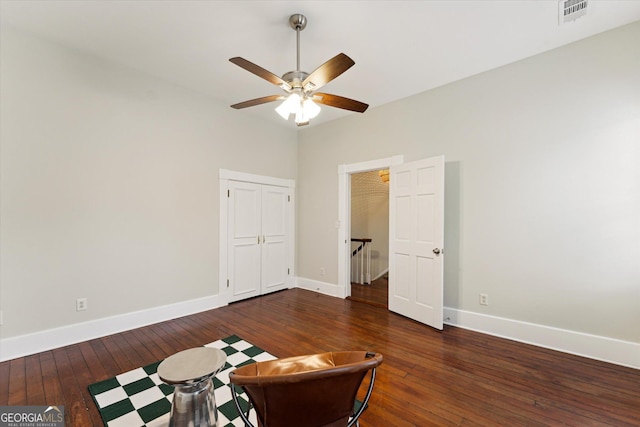 interior space with dark wood-type flooring and ceiling fan