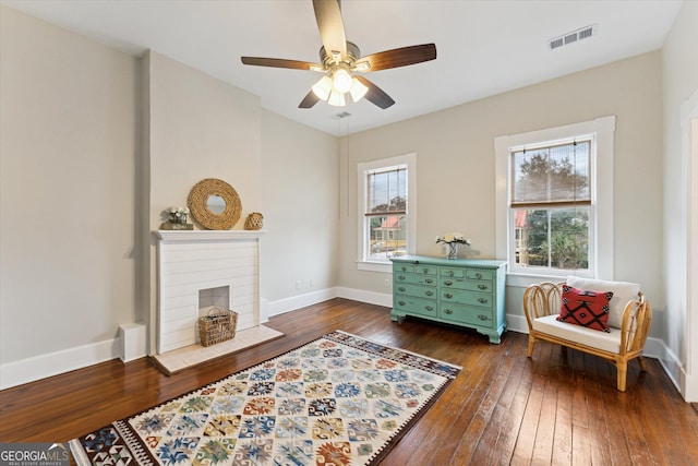 sitting room featuring dark hardwood / wood-style flooring, ceiling fan, and a healthy amount of sunlight