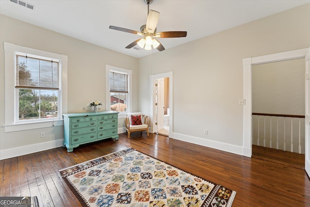 living area featuring dark wood-type flooring, a wealth of natural light, and ceiling fan