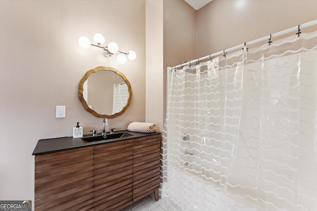 bathroom featuring tile patterned flooring, vanity, and walk in shower