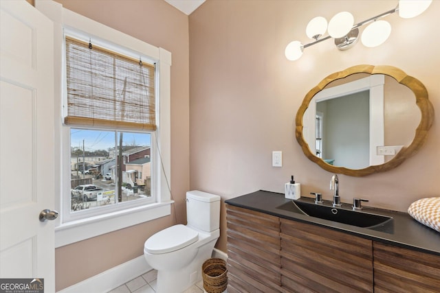 bathroom with vanity, tile patterned flooring, and toilet