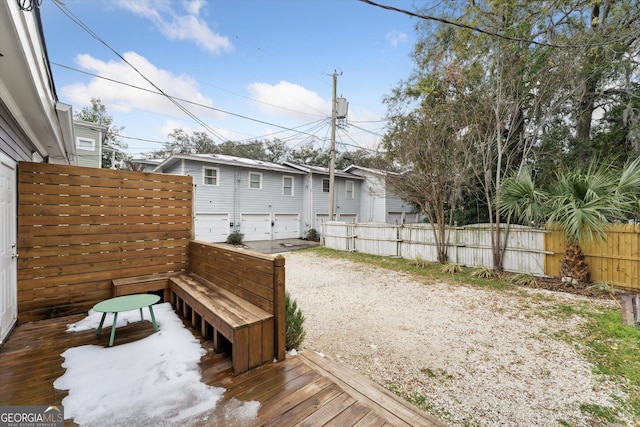 view of yard featuring a garage and a deck