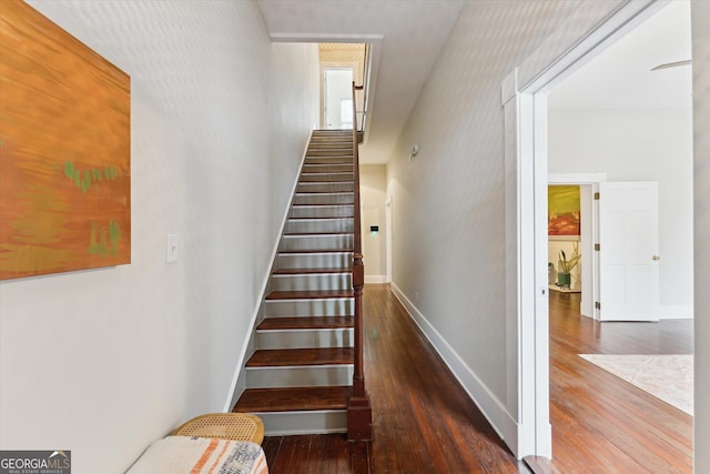 stairway featuring wood-type flooring